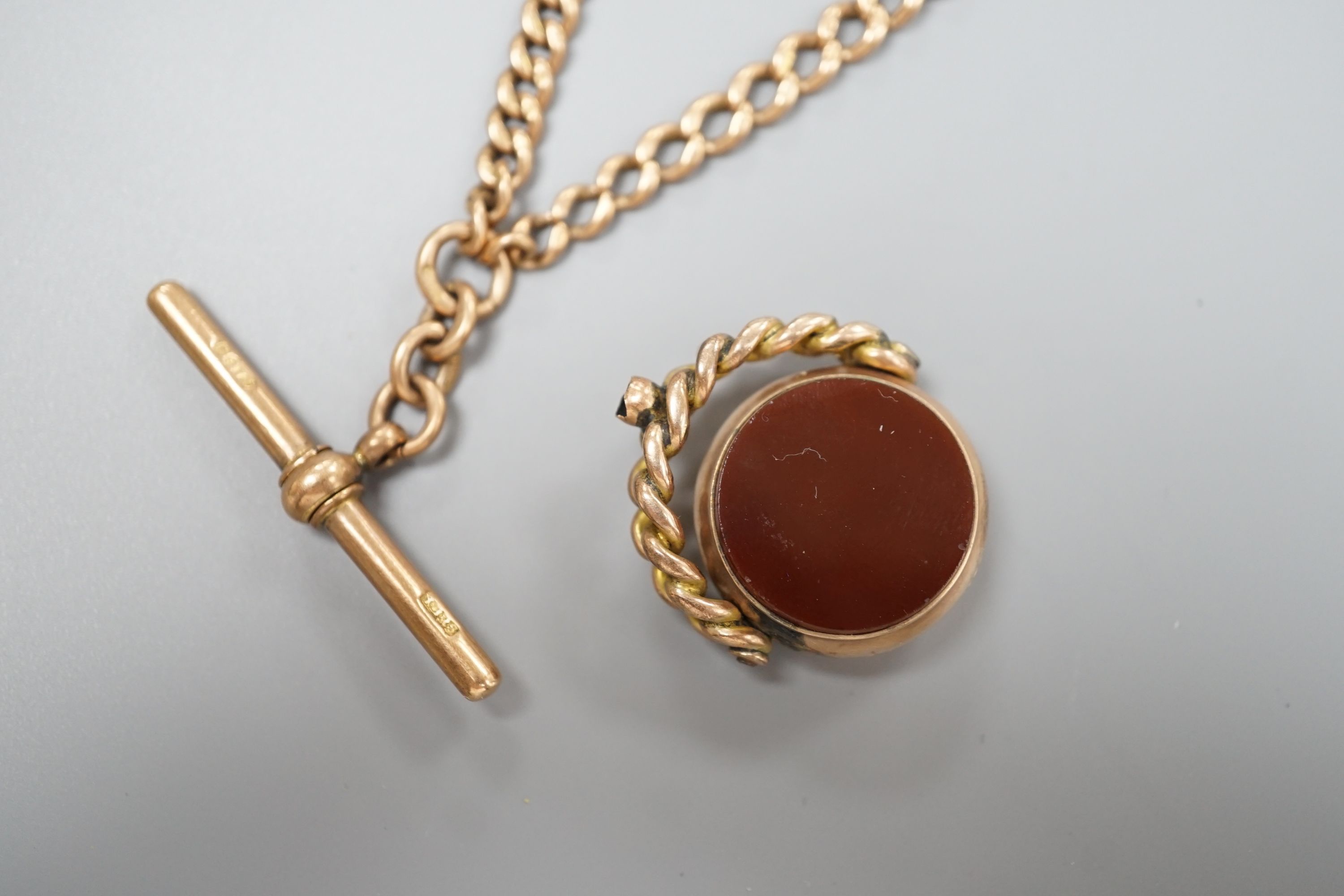 A 9ct gold graduated curblink albert and a 9ct gold and carnelian set spinning fob, gross weight 42.4 grams.